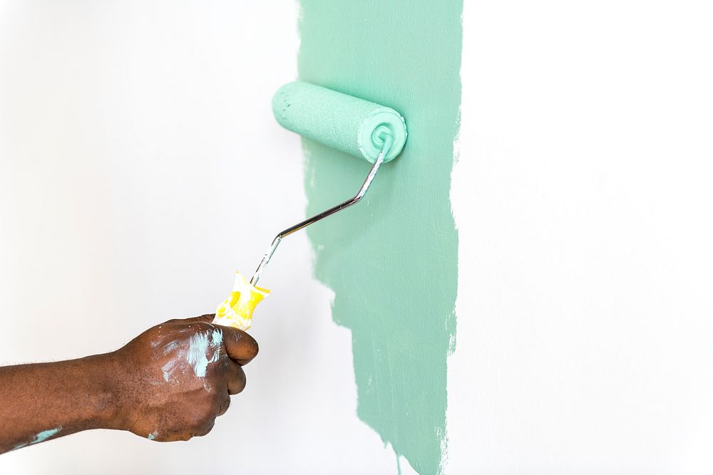 People painting house wall for interior design