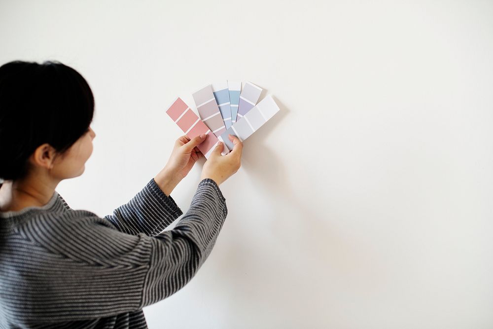 Asian woman choosing wall color