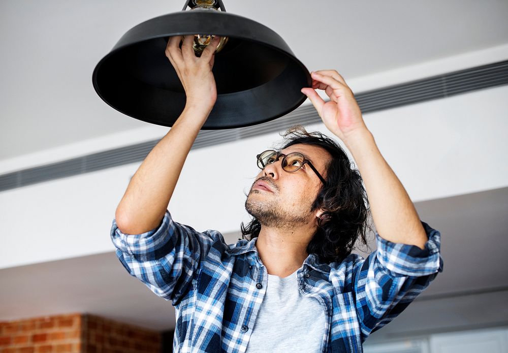 Man changing lightbulb | Photo - rawpixel