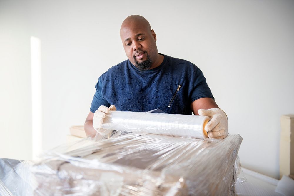 Black man moving furniture