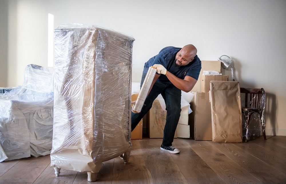Black man moving furniture