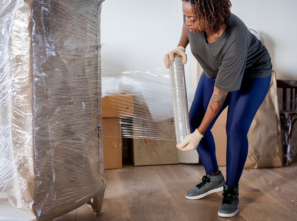 Black woman moving furniture