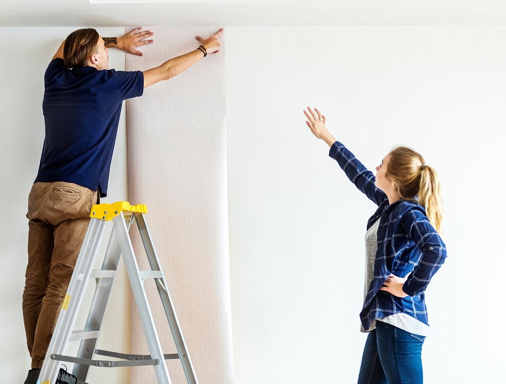 Couple choosing house wallpaper
