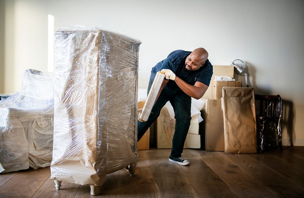An African man moving furniture