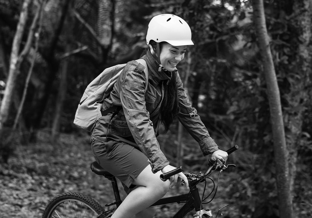 Woman biking in a forest