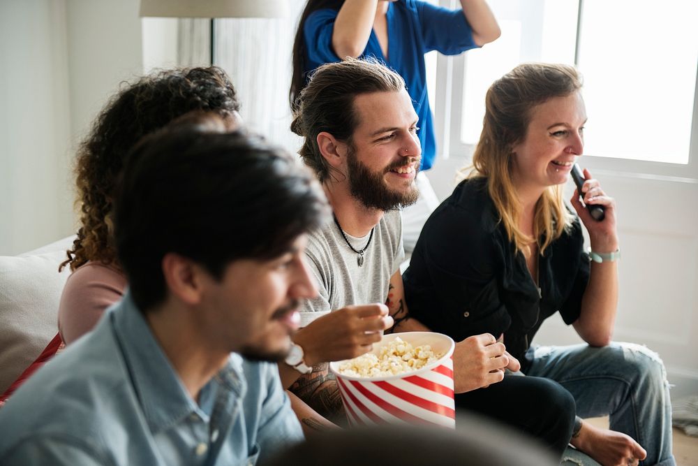Group of diverse friends watching movie together