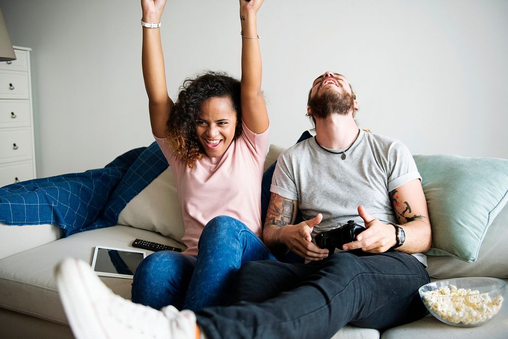 Couple playing game at home together