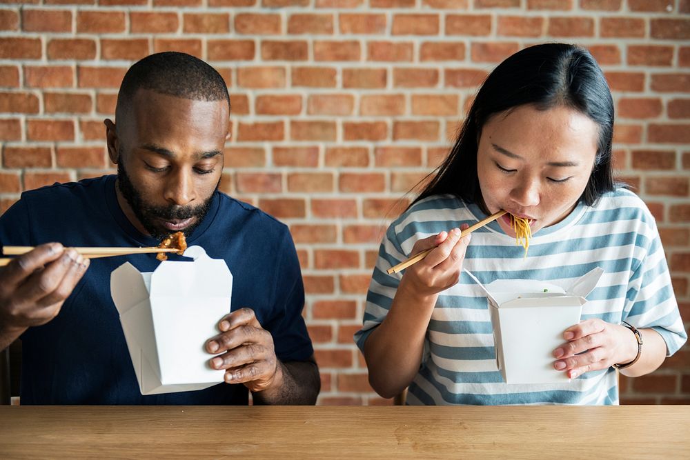 Couple eating Chow mein together