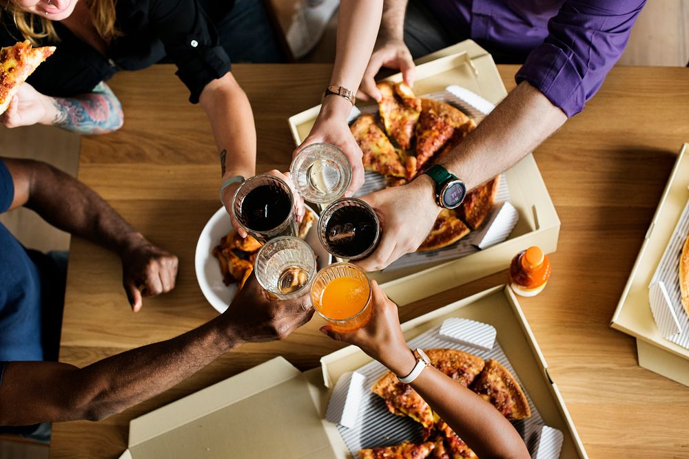 Friends eating pizza together at home