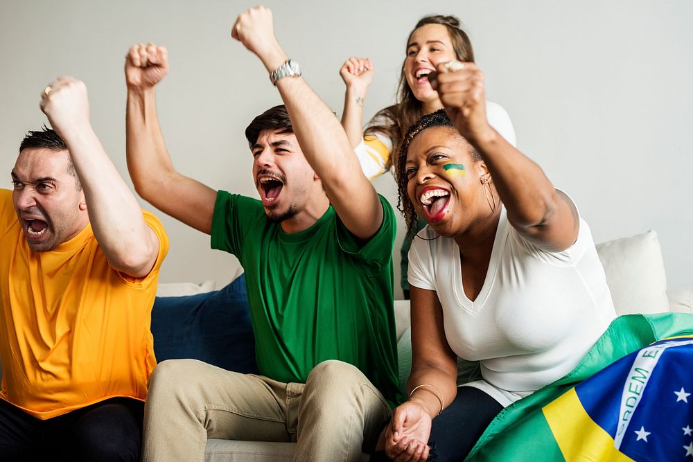 Friends cheering world cup with painted flag