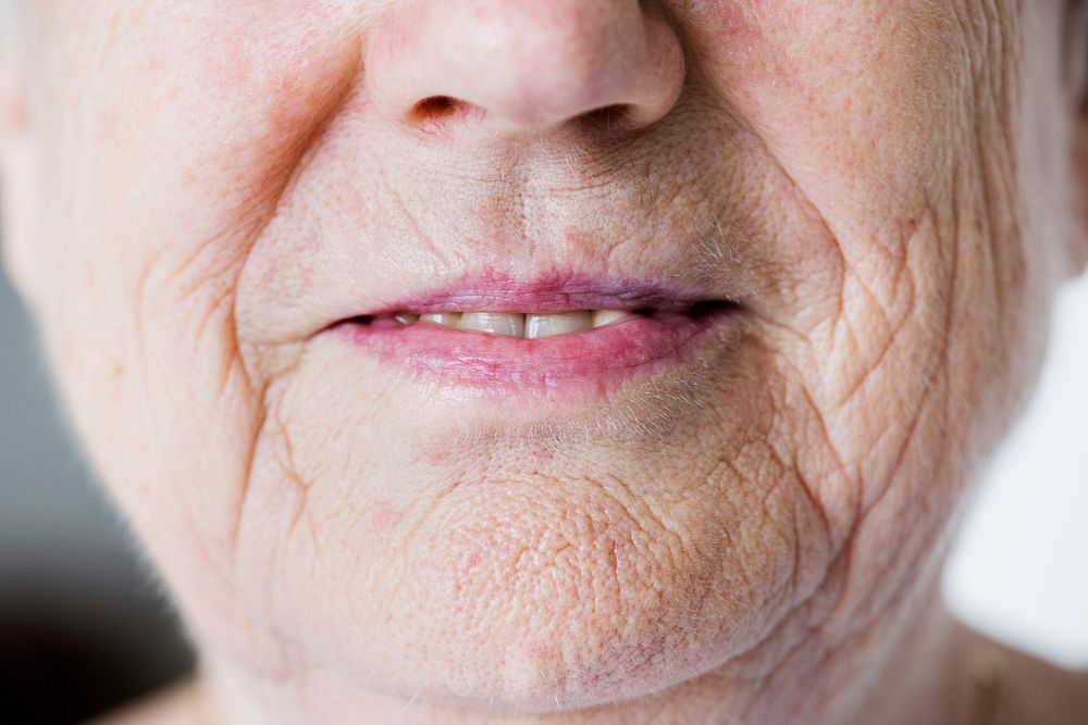 Portrait of white elderly woman closeup on smiling lips