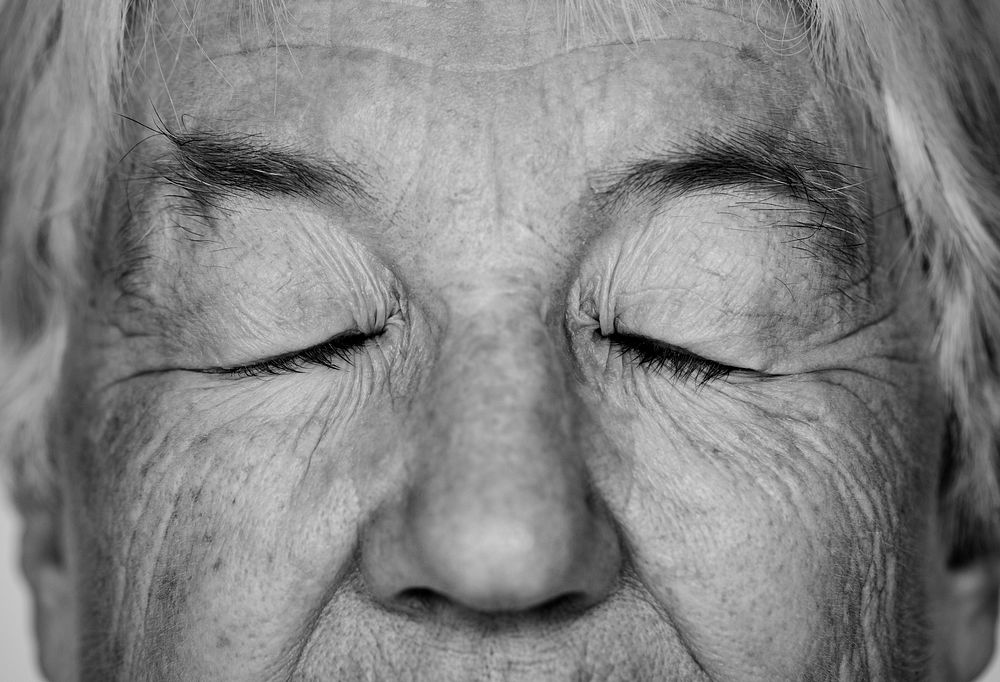 Black and white portrait of a white elderly woman eyes closed
