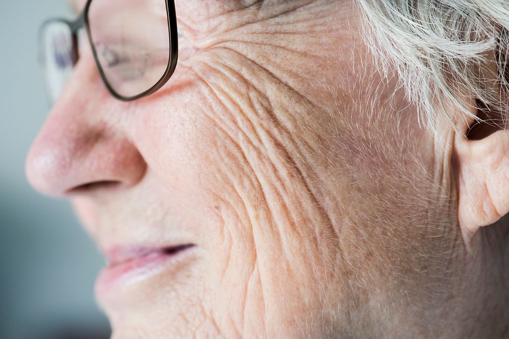 Side closeup portrait of white elderly woman