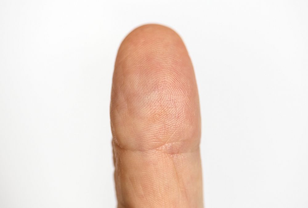 Closeup of finger isolated on white background