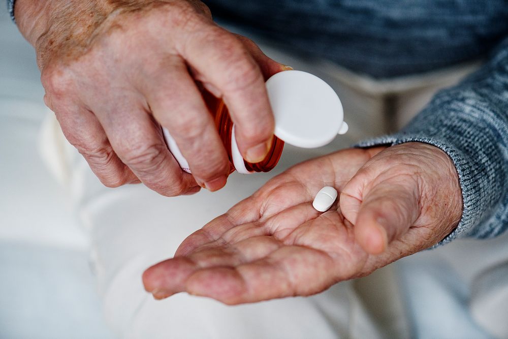 Elderly woman taking a medicine