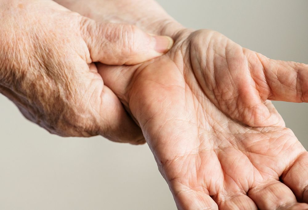 Closeup of elderly hands checking pulse