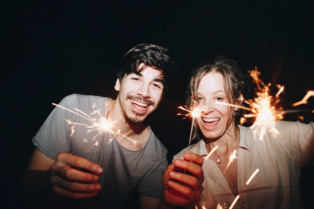Friends celebrating with sparklers in the night