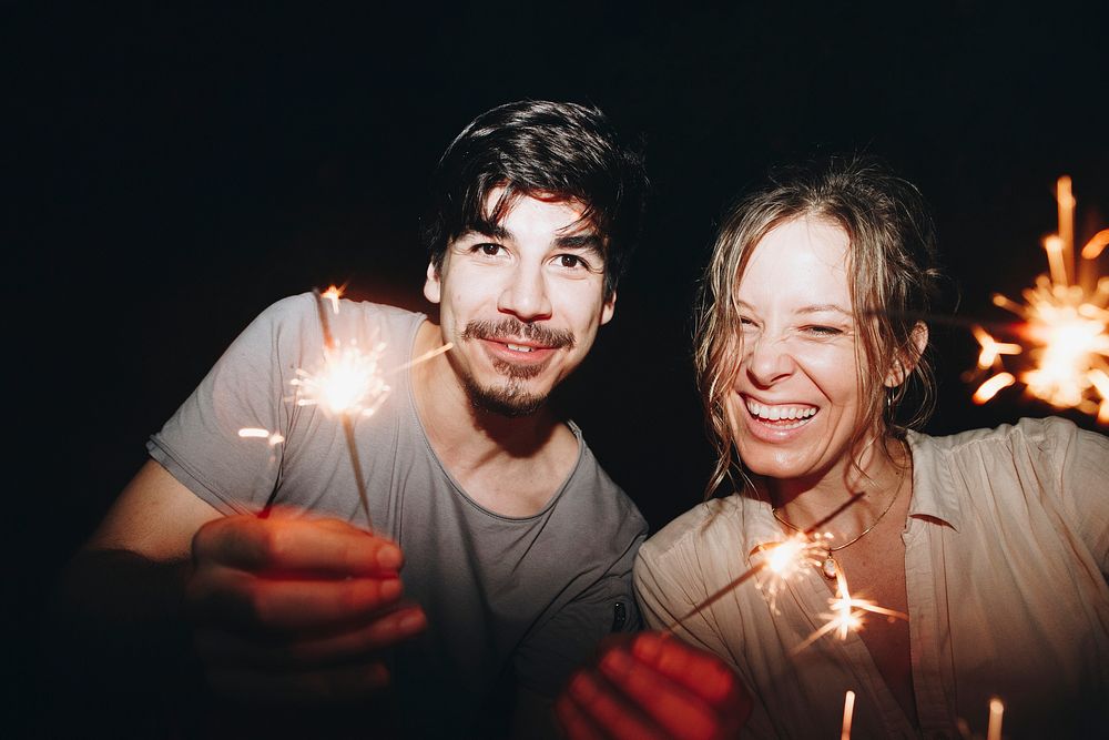 Friends celebrating with sparklers in the night