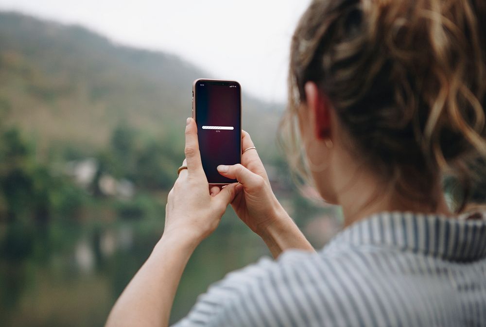 Woman searching for signal with her mobile phone