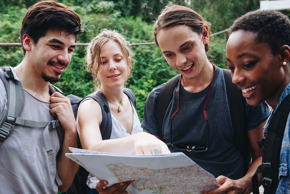 Friends finding their way in nature with a map