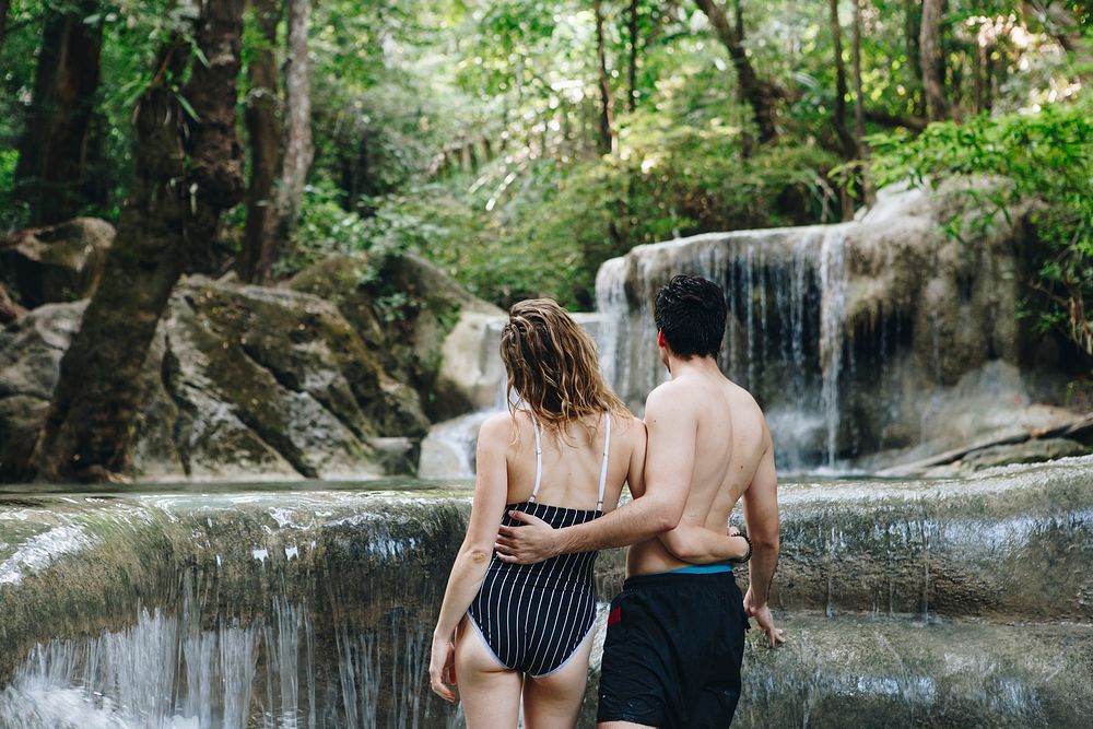 White couple enjoying the waterfall