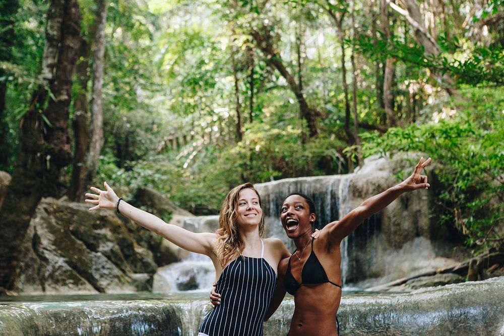Women couple enjoying the waterfall