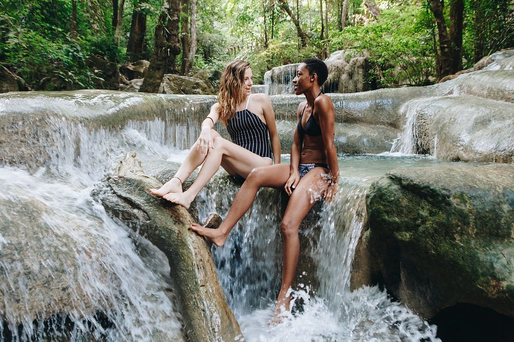 Women couple enjoying the waterfall