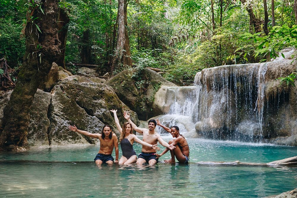 Group of diverse friends enjoying the waterfall