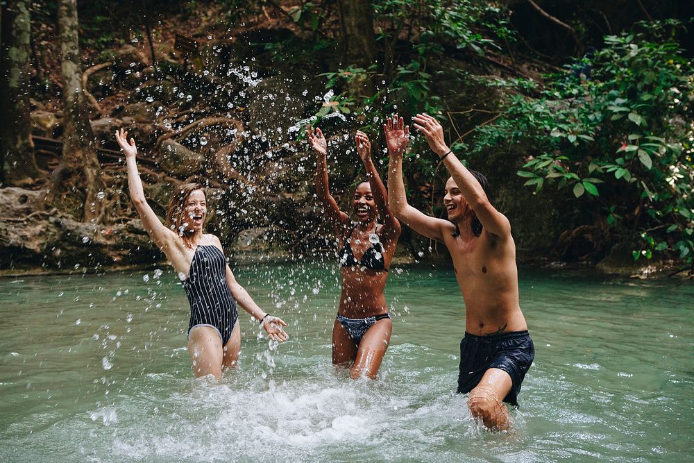 Group of diverse friends enjoying the waterfall