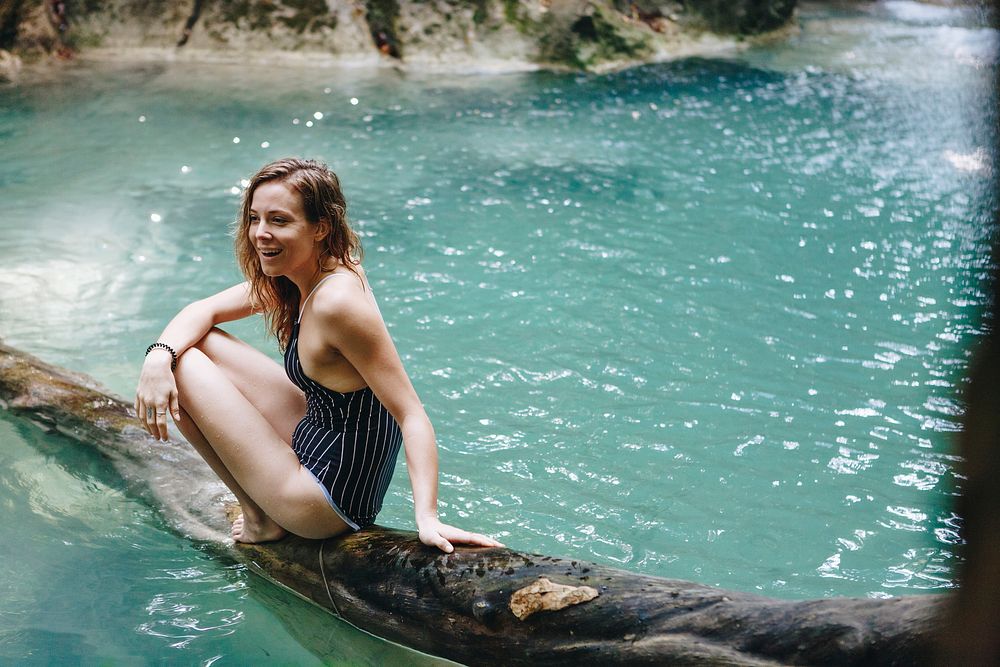 Woman sitting in a natural pond