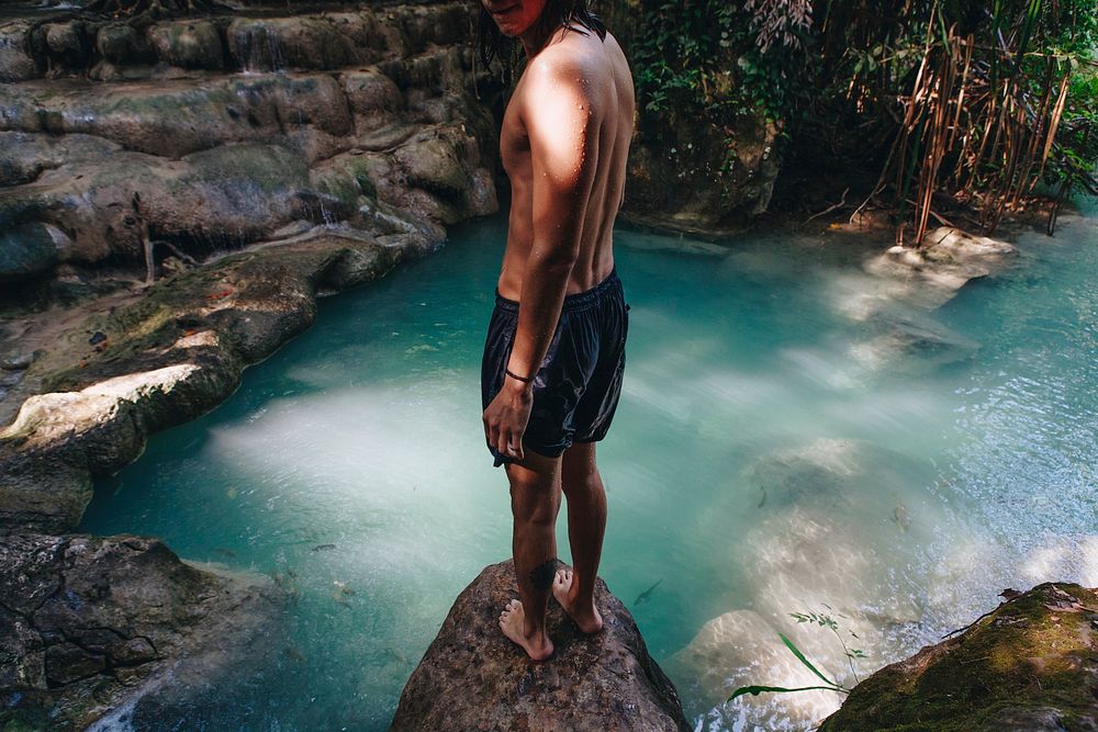 White man enjoying the waterfall