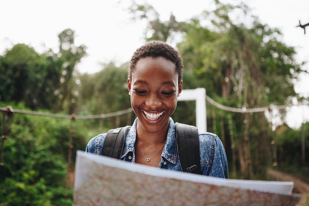 Happy woman navigating with a map