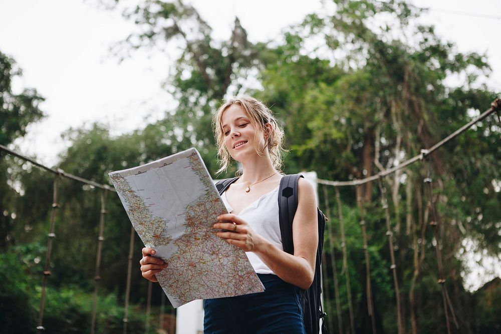 Caucasian woman looking at a map travel and explore concept
