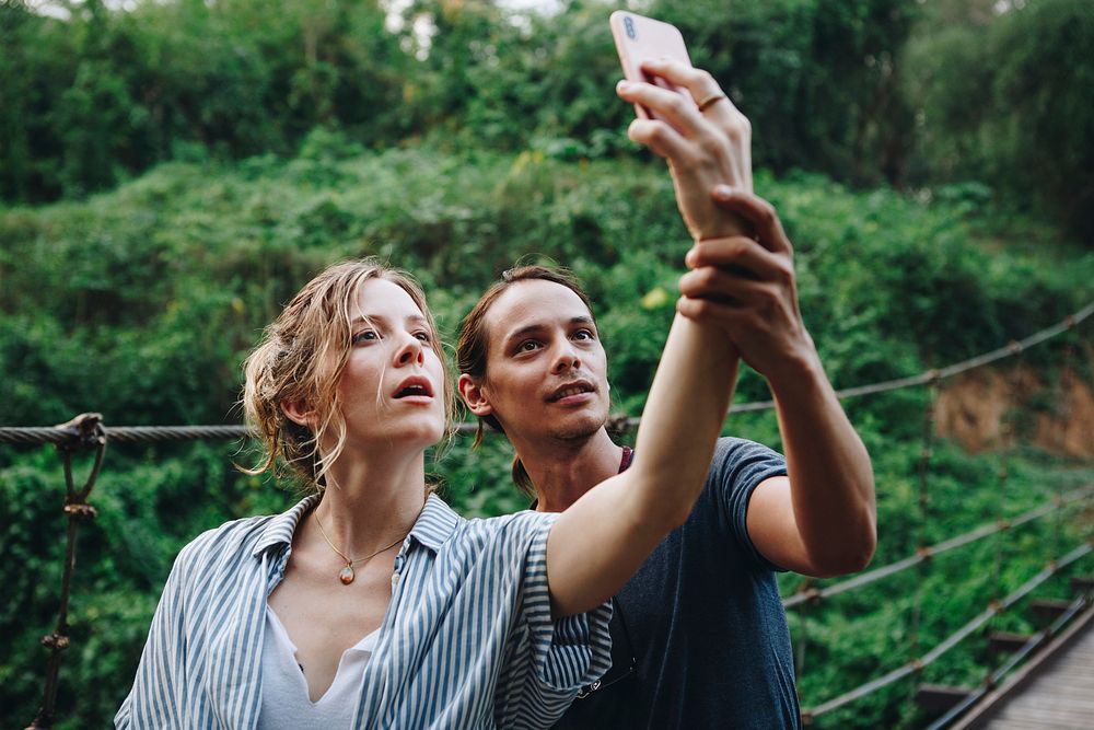 Caucasian woman and man taking a selfie outdoors recreational leisure, freedom and adventure concept