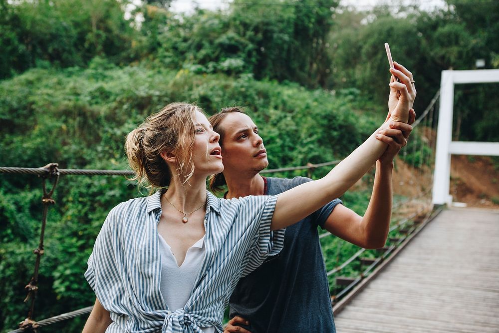 Caucasian woman and man taking a selfie outdoors recreational leisure, freedom and adventure concept