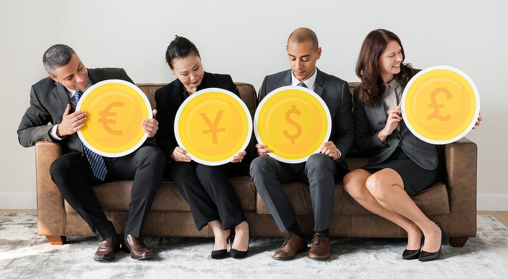 Business people holding currency icons