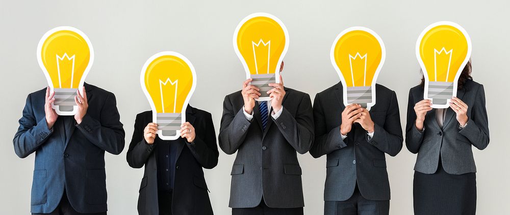 Business people holding lightbulb icons