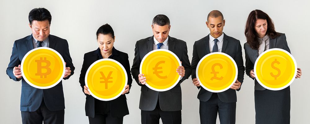 Business people standing and holding currency icons