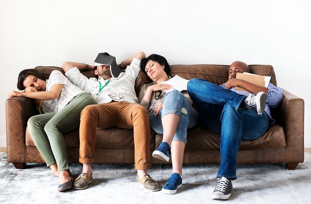 Diverse workers taking rest on couch