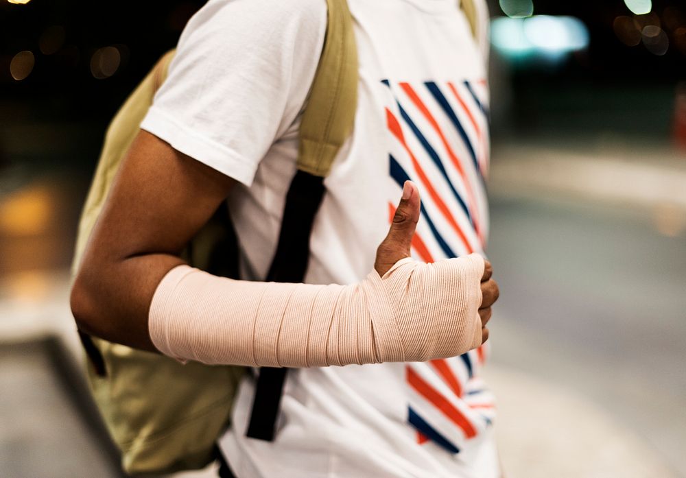 Injured young man with arm support