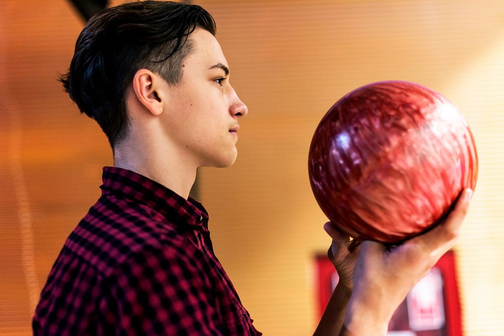 Boy carrying the bowling ball
