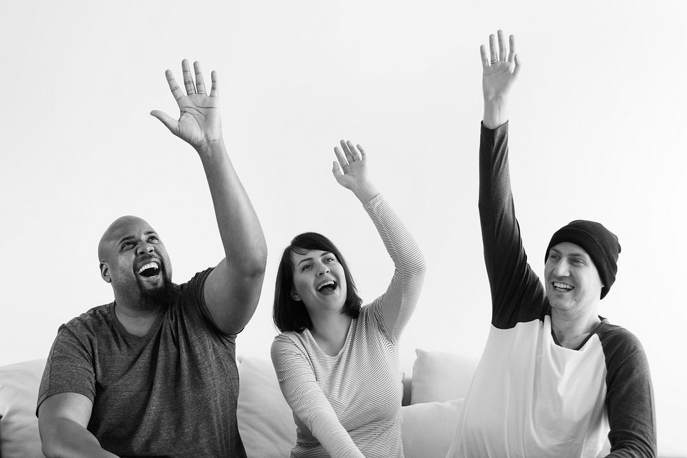 Group of diverse people raising their hands