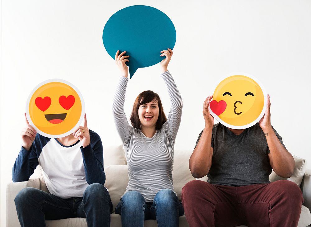 Group of diverse friends sitting on couch with emoticon internet and connection concept