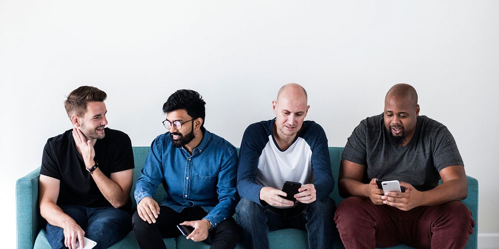 Group of diverse men using mobile phone