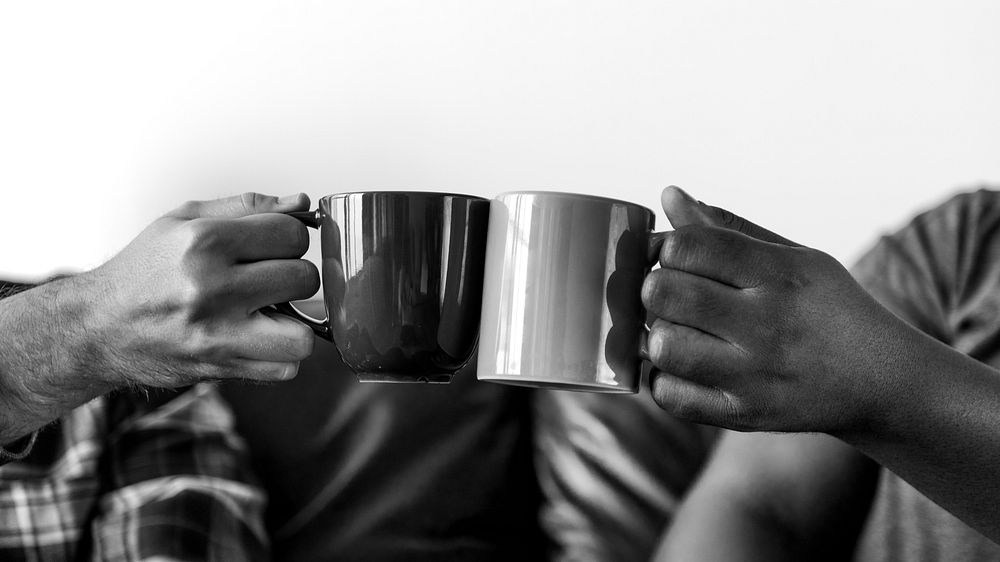 Men toasting coffee cup together
