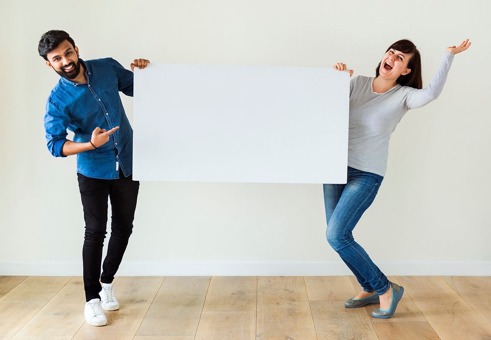 Man and woman holding blank board copyspace