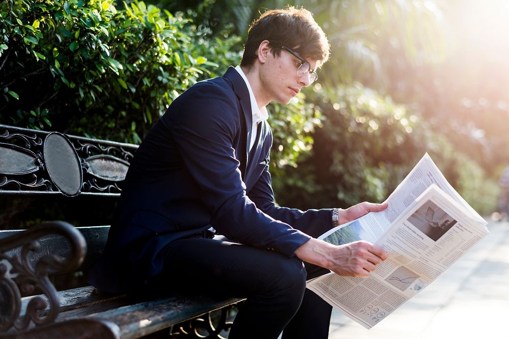 Businessman reading newspaper in the morning