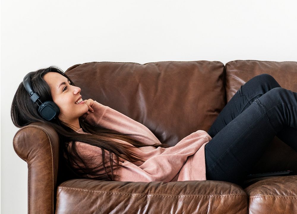 Girl listening to music at home on the sofa