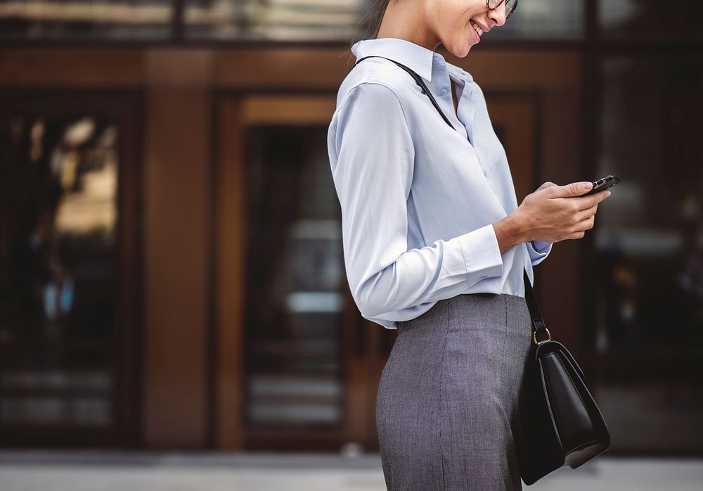 Businesswoman texting on her phone