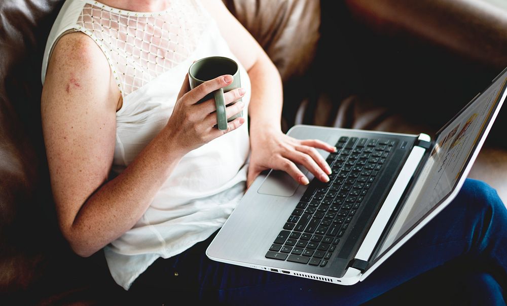 A woman using laptop on a couch